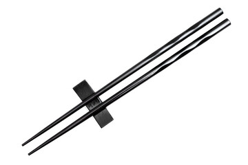 Black chopsticks resting on a base