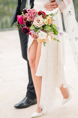 Couple in wedding attire walking 