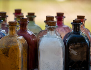 glass bottles with cork stopper with powder colors inside