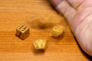The die is cast. A throwing gambling dice on table, close up view. Game with dice.