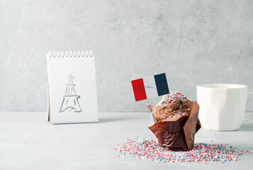 Chocolate cupcake with French flags in honor of Bastille Day, copying the space