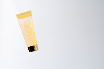 Cosmetic gel product in a transparent beige tube on a white background