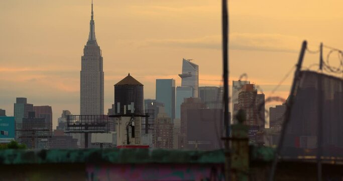 Empire State Building In NYC At Sunset With Barbed Wire Fence In Foreground