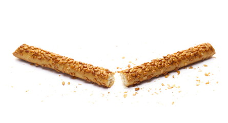Pretzel bread sticks with sesame seeds, snacks broken isolated on white  