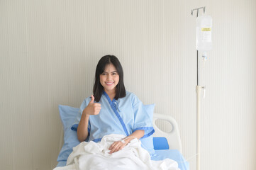 Hopeful and happy young patient woman in hospital, healthcare and medical concept