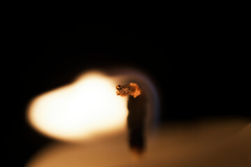 Macro photo of a burning candle on a black background