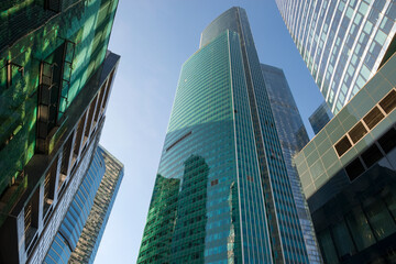 Obraz premium Skyscrapers of the International Business Center Moscow City reflecting the sun on a autumn day against the blue sky