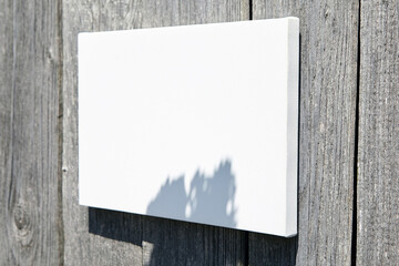 White stretched canvas mockup on wooden wall