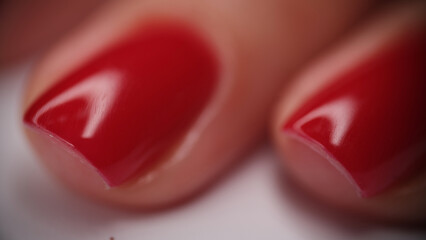 Fototapeta na wymiar Female hands with well-groomed red nails closeup