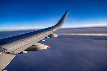 Fototapeta na wymiar view from airplane window above the clouds