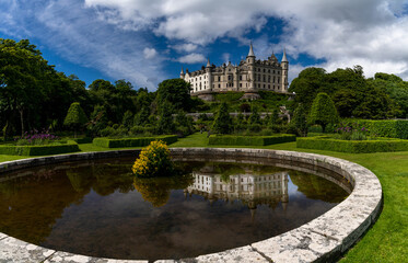 Fototapeta na wymiar view of Dunrobin Castle and Gardens in the Scottish Highlands and castle reflection in the fountain