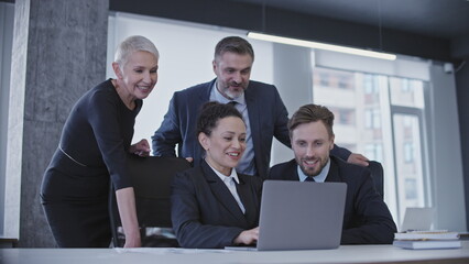 Excited group of company employees finishing work, successful team smiling