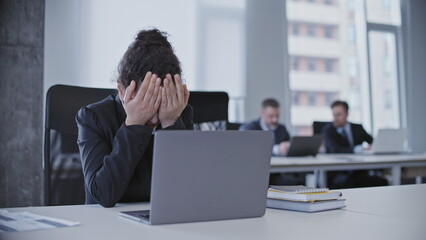 Overworked office worker crying at workplace, stressful job, demanding boss