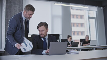 Strict boss telling off male employee, harassment at work, stressful office job