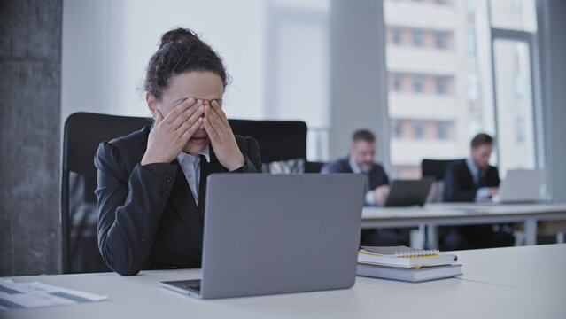 Depressed business woman crying in office, suffering burnout at work, stress