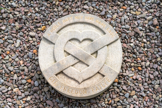 close-up view of the heart stone that marks the grave of Robert the Bruce in the gardens of Melrose Abbey