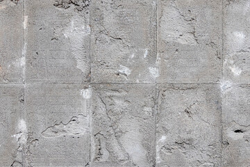 Texture of a concrete wall with traces of dismantled facing tiles