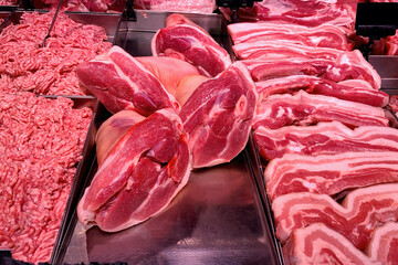 Quality various fresh raw pork meat in fridge showcase at modern butcher shop. - 514506989