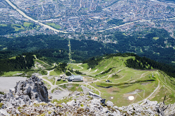 Innsbruck city from above Seegrube station of Nordkette cable car, with winding bike and hike...