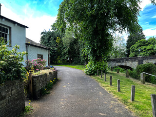 Late evening, on the road leading from the River Aire, with trees and cottages in, Gargrave, Skipton, UK