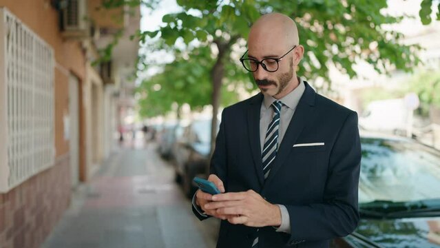 Young hispanic man executive making selfie by smartphone at street