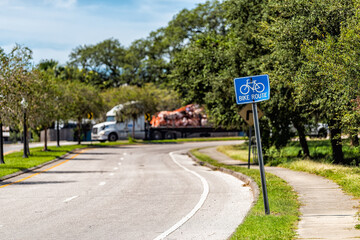 Tarpon Springs, Florida Greek town empty road street with blue sign for bike lane route for...