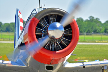 An closeup of a running airplane engine as the plane taxis across the tarmac.