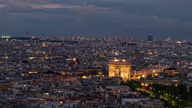 Aerial close-up of illuminated Arc de Triomphe at night in Paris