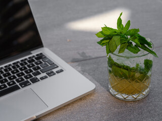 mohito and laptop on floor