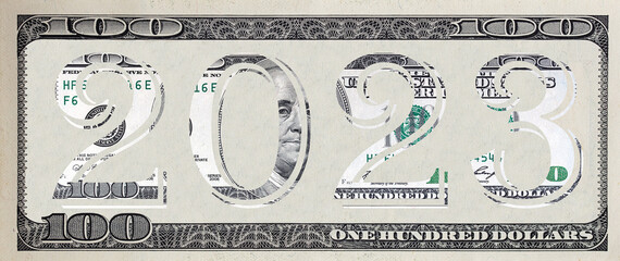 The inscription 2023 made of  100 dollar banknote on 100 dollar banknote