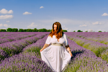 Fototapeta na wymiar Woman with wreath of flowers in lavender field