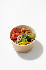 meat soup with vegetables in a paper cup on a white background
