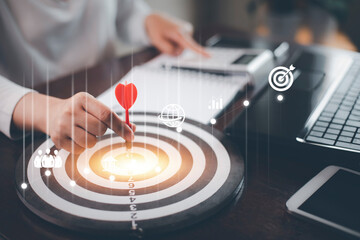 Targeting with marketing business concept, Businesswoman hand holding red dart to the virtual...