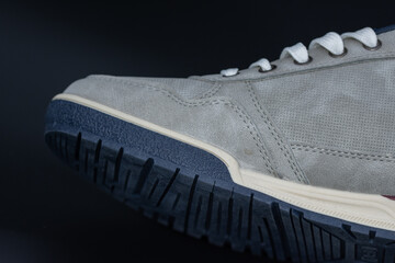 gray sport shoe, stitching detail on sport shoes