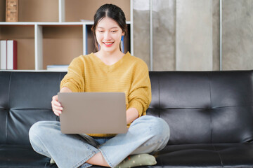 Smiling asian business woman sitting in a modern office