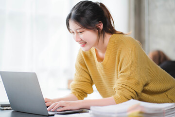 Smiling asian business woman sitting in a modern office