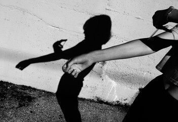 dramatic shadow of the young toxic girl during the drogra initiation in her arm
