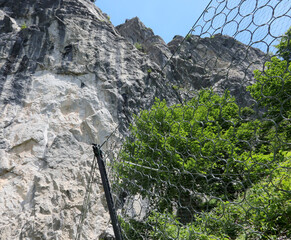 metal mesh for protection against falling stones and boulders on the rocky mountain slope