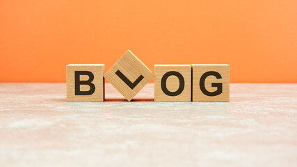 word Blog on wooden cubes. beautiful orange background. business concept. copy space.