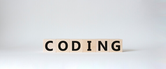 Coding symbol. Concept word Coding on wooden cubes. Beautiful white background. Business and Coding concept. Copy space.