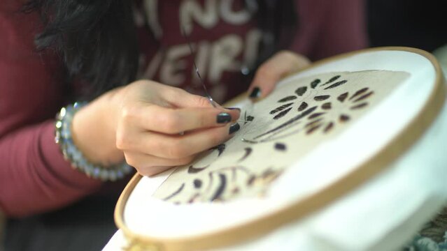 Close-up video shoot of a woman who does handicraft embroidery and the finished products she embroidered