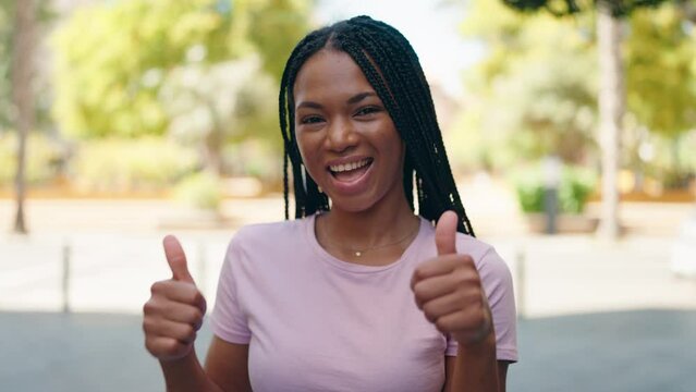 African american woman smiling confident doing ok sign with thumbs up at park