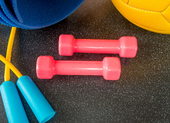 sports accessories dumbbell ball fitness mat jump rope lie on the floor with empty space for...