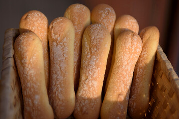 Oblong cookies in a wicker plate. Savoiardi cookies for dessert tiramisu.
