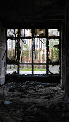 Irpin, Ukraine - May 22, 2022: view from the broken window of a burned room of a house bombed by...