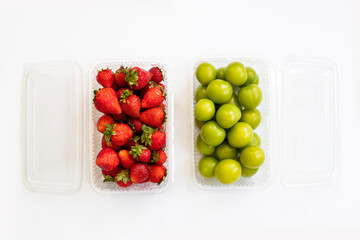 strawberry and green plum on white background