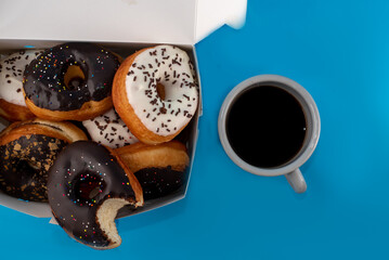 donuts in a box with coffee cup