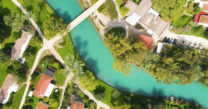 Aerial view of the town with hills in the background and Kibbutzim Stream, Nir David, Northern District, Israel.