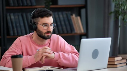 Modern man talking online video call e learning webinar business remotely meetup working at library