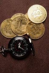 Bitcoin, bitcoin coins and a vintage pocket watch placed on a brown leather background, top view.